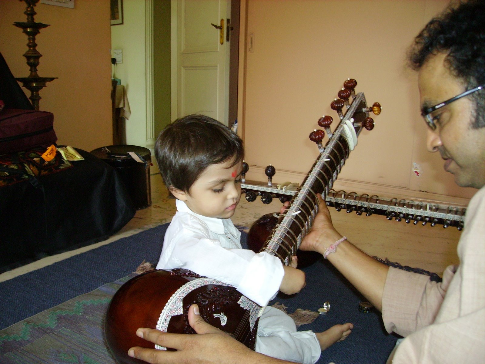 Ishaan as a young child playing sitar